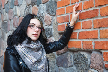 Wall Mural - portrait of young girl near the old stone wall