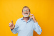 © Tatiana - Portrait of happy senior man talking on the phone posing close-up isolated background
