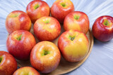 Fototapeta Kuchnia - Red apple in wooden plate on wooden background, US. Red Envy apple on wooden table.