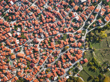 Aerial Drone View Above The Traditional Red Roofs Of A Resort Town Or Village. The Concept Of Real Estate And Travel In Europe
