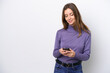 © luismolinero - Young caucasian woman isolated on white background sending a message with the mobile
