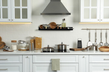 Poster - Countertop with different cooking utensils in kitchen