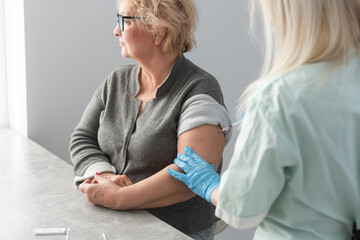 Wall Mural - close up doctor holding syringe before make injection to patient in medical mask. Covid-19 or coronavirus vaccine