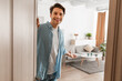 © Prostock-studio - Cheerful guy inviting people to enter home