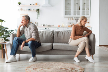 Wall Mural - Offended Mature Spouses Sitting Back-To-Back Not Speaking After Quarrel Indoor