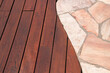 Teak wood deck and marble stone decorative tiled walkway detail, hardwood decking installed next natural marble stone slabs