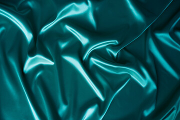 Wall Mural - Photography of beautiful wavy turquoise silk satin luxury cloth fabric with monochrome background design. 