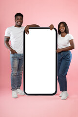 Wall Mural - Couple showing white empty smartphone screen leaning on display