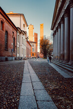 Urban View Of Three Towers In The Historic Centre Of Pavia, With People