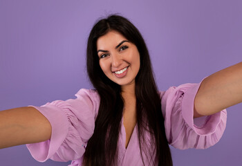 Photography concept. Portrait of positive armenian woman taking selfie picture, making front selfportrait