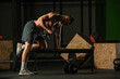 © qunica.com - Athletic caucasian man doing a dumbbell triceps kickback with his right arm on a horizontal bench.