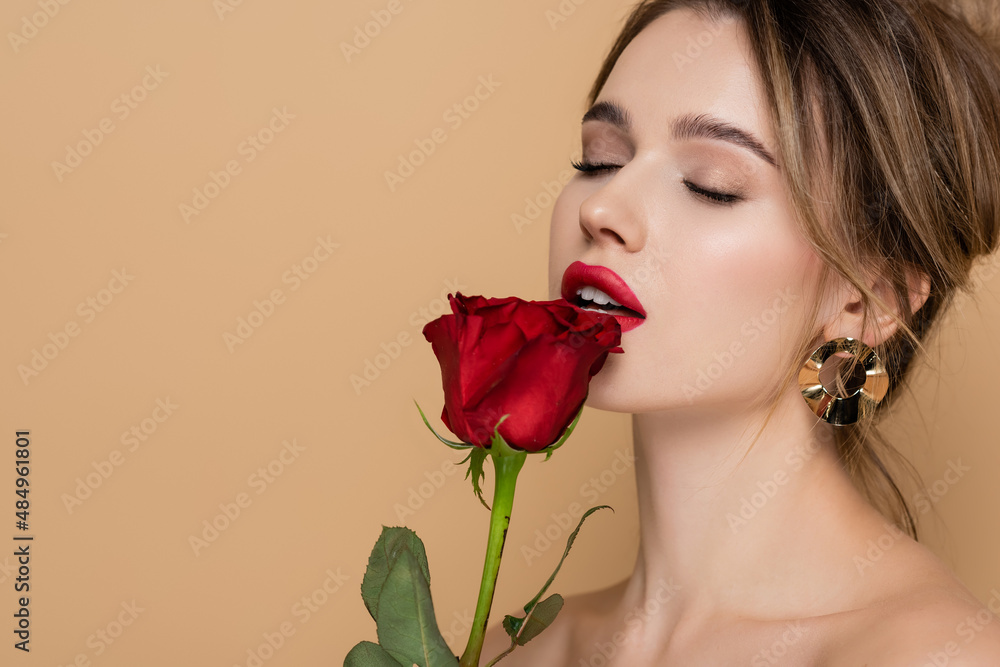 pretty young woman with closed eyes holding red rose near lips isolated ...