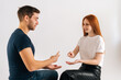 © dikushin - Studio shot of cheerful beautiful young man and woman playing rock scissors paper game on white isolated background. Concept of resolving conflicts in a peaceful and ecological way.