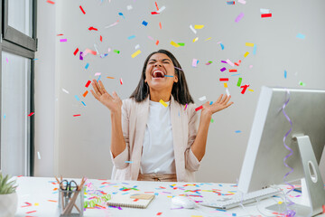 Wall Mural - Young business woman having fun time catching confetti