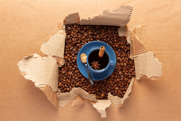 Poster - Cup of coffee and beans in torn cardboard paper. Coffee bean