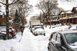 A snow filled residential street  being shovelled out after a snow fall.  Shot in the Toronto’s Beaches in February.