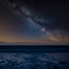 Canvas Print - Digital composite image of Milky Way over Absolutely beautiful landscape images of Holywell Bay beach in Cornwall UK during golden hojur sunset in Spring