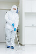 防塵服で除菌清掃する女性
