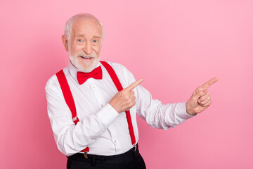 Poster - Portrait of attractive cheerful gray-haired guy showing copy blank space ad idea isolated over pink pastel color background