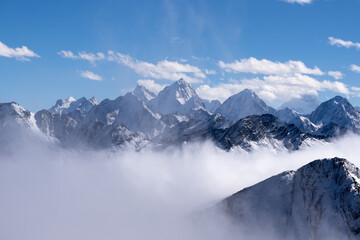 Wall Mural - An aerial view of snow-covered mountain peaks