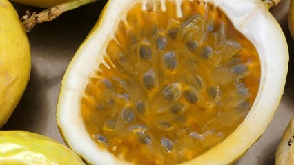 Wall Mural - Passion fruit background with whole and one half cut chinola, top view. A lot of maracuja. Tropical fruits backdrop