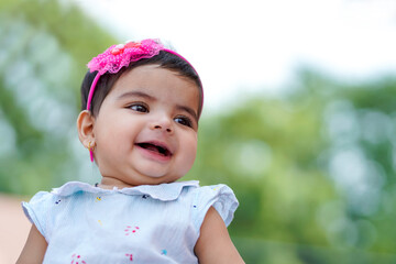 Canvas Print - Indian baby girl child playing and giving smile