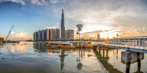 Wall Mural - Riverside cityscape under beautiful sunset at evening in Saigon, Vietnam