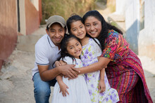 Portrait Of A Latin Family Hugging In Rural Area - Happy Hispanic Family In The Village