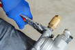 Installation of heating and water supply systems. A plumber tightens nuts on a metal pipeline using a wrench. Unrecognizable person. selective focus