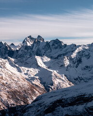 Wall Mural - Snowy mount Ushba. Greater Caucasus ridge. Sunny day. Before suset. View from russian side