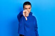 © Krakenimages.com - Beautiful hispanic woman with short hair wearing turtleneck sweater looking unhappy and angry showing rejection and negative with thumbs down gesture. bad expression.