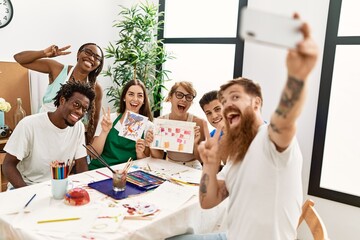 Canvas Print - Group of people smiling happy make selfie by the smartphone sitting on the table at art studio.