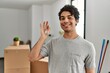 © Krakenimages.com - Young hispanic man smiling happy holding key of new home.