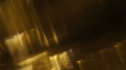 Golden bokeh crystal abstract light rays background, shiny flare texture photo overlay optical lens prism reflection. Use screen overlay mode.