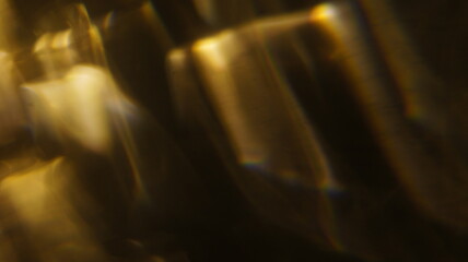Golden bokeh crystal abstract light rays background, shiny flare texture photo overlay optical lens prism reflection. Use screen overlay mode.