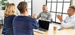 © Krakenimages.com - Group of middle age business workers smiling and clapping to partner at the office.