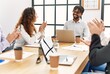 © Krakenimages.com - Group of business workers smiling and clapping to partner at the office.