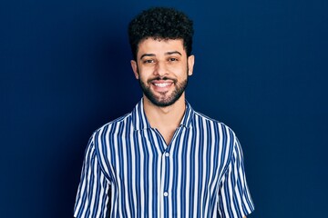 Sticker - Young arab man with beard wearing casual striped shirt with a happy and cool smile on face. lucky person.