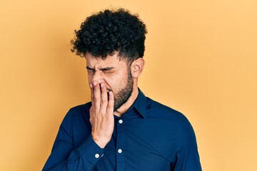 Sticker - Young arab man with beard wearing casual shirt bored yawning tired covering mouth with hand. restless and sleepiness.