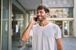 © Krakenimages.com - Young hispanic man smiling confident talking on the smartphone at street