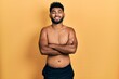 © Krakenimages.com - Arab man with beard wearing swimwear shirtless happy face smiling with crossed arms looking at the camera. positive person.