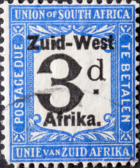 Wall Mural - South West Africa - circa 1924: a postage stamp from South West Africa, now Namibia shows a numeral 3 d and the overprint in Dutch: South West Africa