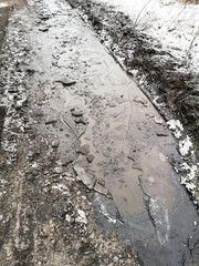 Wall Mural - Frozen puddles on a dirt road.