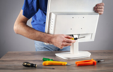 Wall Mural - Electrician engineer repairing computer monitor.