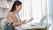 © Puwasit Inyavileart - Woman greeting colleague using laptop video chat and greeting with cheerful gesture , Freelancers work or learn in private rooms at home, Online communication, VDO Call ,Home lifestyle.