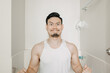 © Sevendeman - Funny face expression of Asian man try to poop in the toilet.