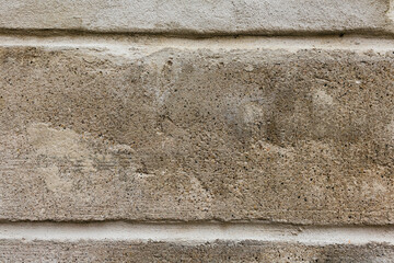 detail of a plastered light brown wall with two horizontal joints. Renovation would be necessary. Pattern for grunge background.