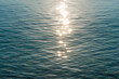 Detail of a sunlight reflecting in glittering sea. sparkler in water - background. sea water with sun glare and ripple. Powerful and peaceful nature concept
