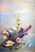 Flowers On Old Grunge Blue Wooden Background (dandelions Thyme Mint Bells Chamomile Lupine ).