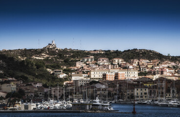 Canvas Print - A view of a residential area by the sea under the blue sky